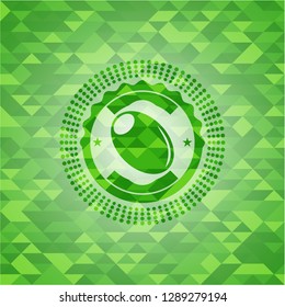 olive icon inside green emblem with mosaic background