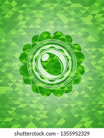 olive icon inside green emblem with mosaic ecological style background