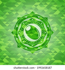olive icon inside green emblem with triangle mosaic background. 