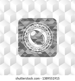 olive icon inside grey badge with geometric cube white background