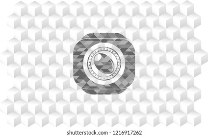 olive icon inside grey emblem with geometric cube white background