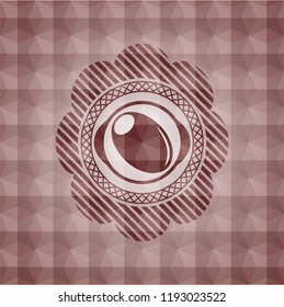 olive icon inside red seamless badge with geometric pattern.