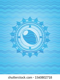 olive icon inside sky blue water emblem background.