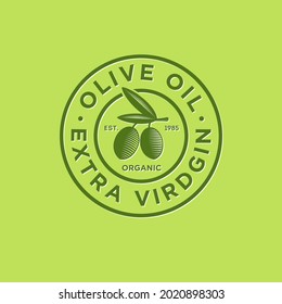 Olive oil logo. Ripe olives and leaves with letters on a circle. Engraving style. 