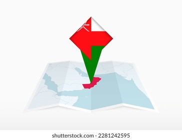 Oman is depicted on a folded paper map and pinned location marker with flag of Oman. Folded vector map.