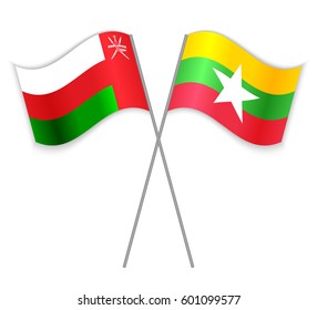 Omani and Burmese crossed flags. Oman combined with Myanmar isolated on white. Language learning, international business or travel concept.