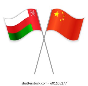 Omani and Chinese crossed flags. Oman combined with China isolated on white. Language learning, international business or travel concept.
