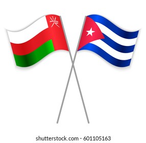 Omani and Cuban crossed flags. Oman combined with Cuba isolated on white. Language learning, international business or travel concept.