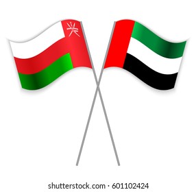 Omani and Emirian crossed flags. Oman combined with United Arab Emirates isolated on white. Language learning, international business or travel concept.