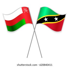 Omani and Kittitian crossed flags. Oman combined with Saint Kitts and Nevis isolated on white. Language learning, international business or travel concept.