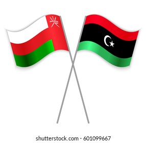 Omani and Libyan crossed flags. Oman combined with Libya isolated on white. Language learning, international business or travel concept.