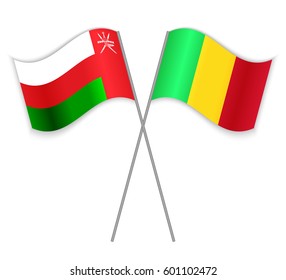 Omani and Malian crossed flags. Oman combined with Mali isolated on white. Language learning, international business or travel concept.