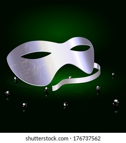 on an black-green background is a silver carnival half mask