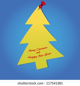 on a blue background Christmas tree hanging on a pushpin