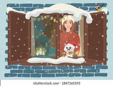 On Christmas night a girl and her cat looks up at the sky out of the window, waiting for Santa Claus. The interior of the house is illuminated for Christmas.