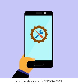 On the smartphone screen icon with gear, screwdriver and wrench