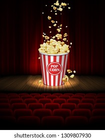 On the stage in the cinema there is a big jar of popcorn on the background of a red curtain. 3D vector. High detailed realistic illustration