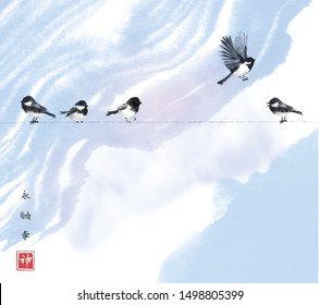 One bird flying in the sky and four little birds sitting on a wire. Traditional oriental ink painting sumi-e, u-sin, go-hua. Hieroglyphs - eternity, freedom, happiness, spirit