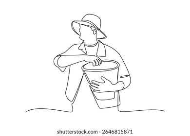 one continuous line draw of man picking up the fruit harvest. Farmer minimalist concept. Harvest time concept. Harvesting.