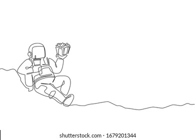 One continuous line drawing of cosmonaut laying relax on moon surface eat french fries and drinking soft soda. Fantasy outer space astronaut life concept. Single line draw design vector illustration