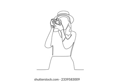 One continuous line drawing of a female photographer taking a photo from the front
