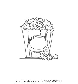 One continuous line drawing fresh delicious sweet pop corn on stripped paper box and scattered on table. Snack for watching movies concept. Modern single line draw design vector graphic illustration