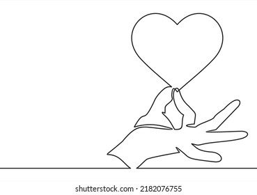 One continuous line drawing of hand holding heart.vector illustration