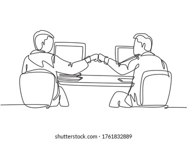 One continuous line drawing of two young happy male worker bump their fist to celebrate their success at the office. Business teamwork concept single line graphic draw design vector illustration