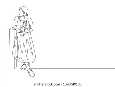 One continuous line drawing of young happy muslim girl with veil leaning on the wall. Pretty beauty middle east women model in trendy hijab fashion concept single line draw design vector illustration