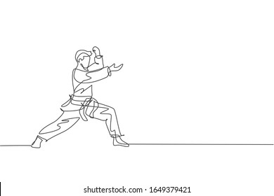 One continuous line drawing of young talented karateka man train pose for duel fighting at dojo gym center. Mastering martial art sport concept. Dynamic single line draw design vector illustration