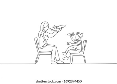 One continuous line drawing of young mother and her daughter sitting on chair and playing airplane toy together at home. Happy family parenthood concept. Single line draw design vector illustration