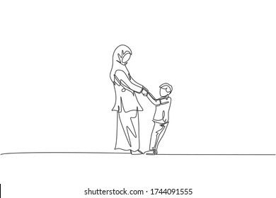 One continuous line drawing of young Islamic mother playing and dancing with her son together. Arabian muslim happy loving parenting family concept. Dynamic single line draw design vector illustration