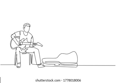 One continuous line drawing of young happy male guitarist sitting and busking by playing guitar on uptown road. Street musician artist performance concept single line draw design vector illustration