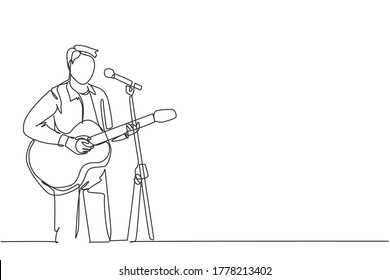 One continuous line drawing of young happy male guitarist playing acoustic guitar and singing on music festival stage. Musician artist performance concept single line draw design vector illustration