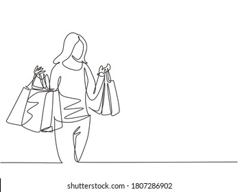 One continuous line drawing young happy beauty woman holding paper bags after buying dress, make up, cosmetic, fashion in mall. Shopping in mall concept. Single line draw design illustration