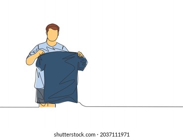 One Continuous Line Drawing Of Young Rising Football Star Holding His New Jersey While Introduced At Press Conference. Soccer Match Sports Concept. Single Line Draw Design Vector Illustration