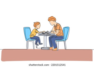One continuous line drawing young dad and his son siting on chair and playing chess game together at home. Happy family parenthood concept. Dynamic single line draw design vector illustration graphic