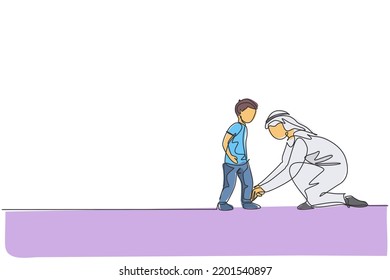 One continuous line drawing of young Arabian dad help his son to tie shoelaces before go to school. Happy Islamic muslim loving parenting family concept. Single line draw design vector illustration