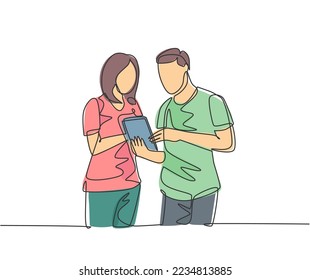 One continuous line drawing of young male and female employee talking about company target while staring tablet screen. Business goal discussion concept single line draw design vector illustration