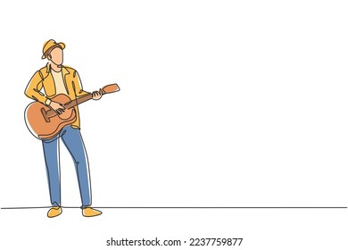 One continuous line drawing of young happy male guitarist wearing hat and playing acoustic guitar on street road. Trendy musician artist performance concept single line draw design vector illustration