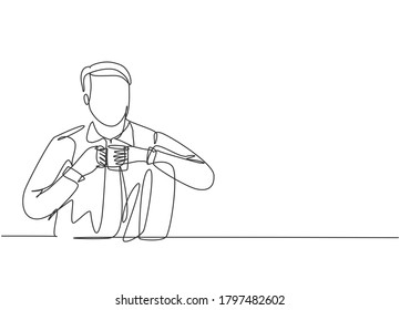One continuous single line drawing of young happy office worker leaning his body to a sofa while holding a mug of coffee. Drinking coffee or tea concept cartoon design vector illustration