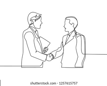 One line drawing of two young businessmen meeting and handshaking to deal an agreement. Single line drawing of business concept. Vector illustration design