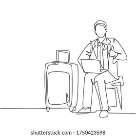 One line drawing of young happy businessman giving thumbs up gesture while opening the laptop waiting in the airport. Business travel journey concept. Continuous line draw design vector graphic