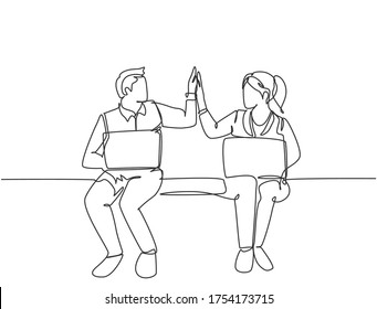 One line drawing of young happy couple business man and business woman opening their laptop and giving high five gestures. Business teamwork concept. Continuous line draw design vector illustration