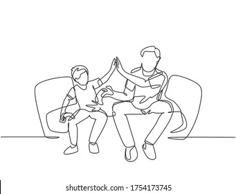 One line drawing of young happy father have fun playing console video game with his son on the couch together. Parenting family concept. Modern continuous line draw graphic design vector illustration