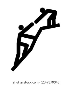 One man helps another on a cliff