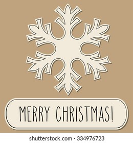 One paper cut snowflake and hand written Christmas greetings in a frame.