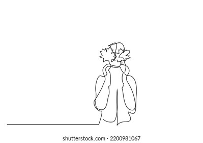 one person holds fallen autumn leaves in her hand to close her eyes autumn concept single line