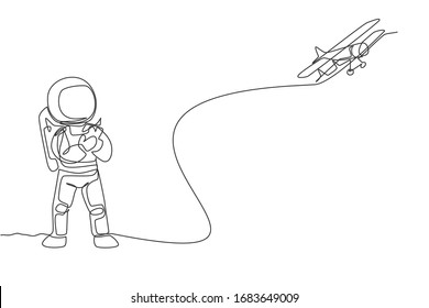 One single line drawing of astronaut playing airplane radio control in moon land graphic vector illustration. Doing hobby while leisure time in deep space concept. Modern continuous line draw design