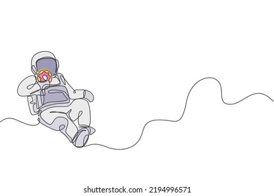 One single line drawing of astronaut flying in cosmos galaxy while eating sweet sugar donut graphic vector illustration. Fantasy outer space life concept. Modern continuous line draw design
